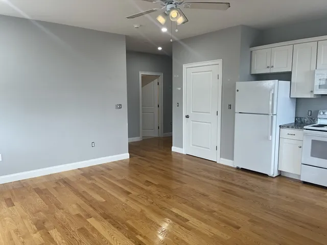 a view of a kitchen with a sink and a refrigerator