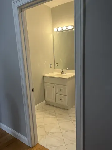 a bathroom with a mirror sink and vanity