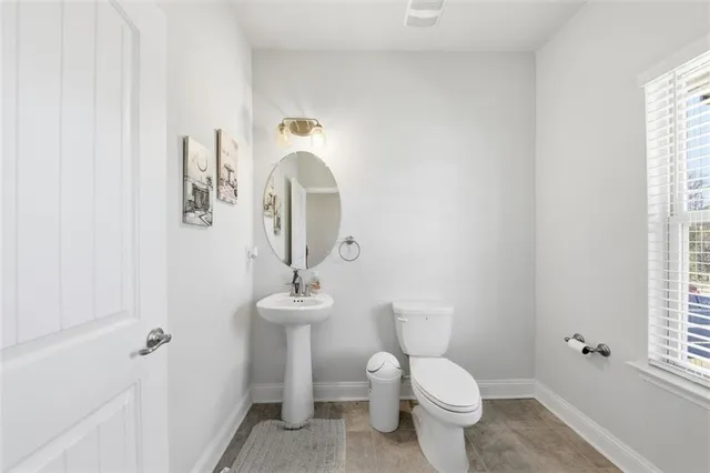 a white toilet sitting next to a bathroom sink