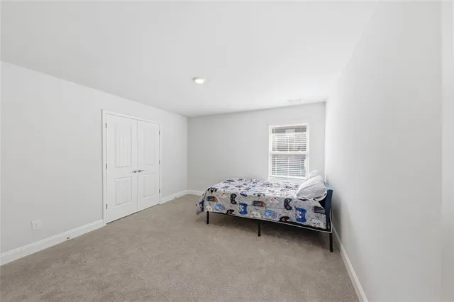 a bedroom with bed and window