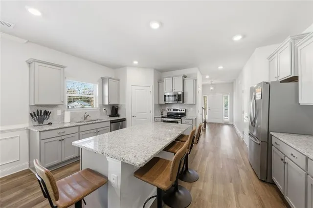 a large kitchen with a table and chairs