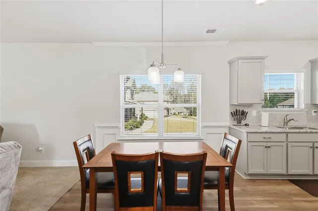 a dining room with furniture and window