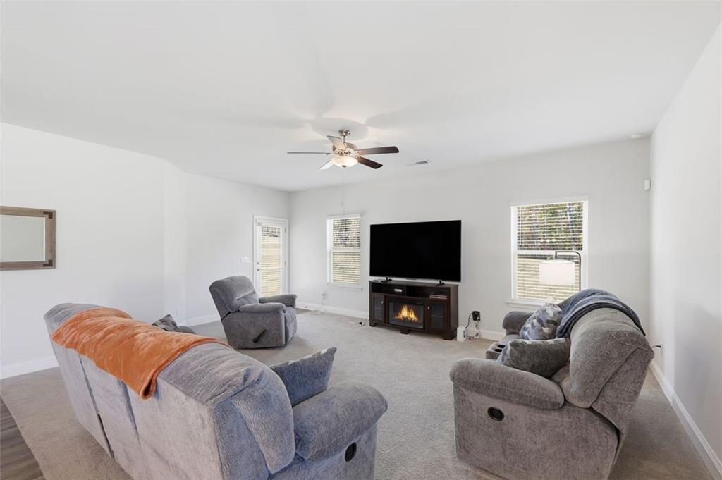 1861 Abbey Road Griffin, GA 30223 - Photo 8 of 24 a living room with furniture and a flat screen tv