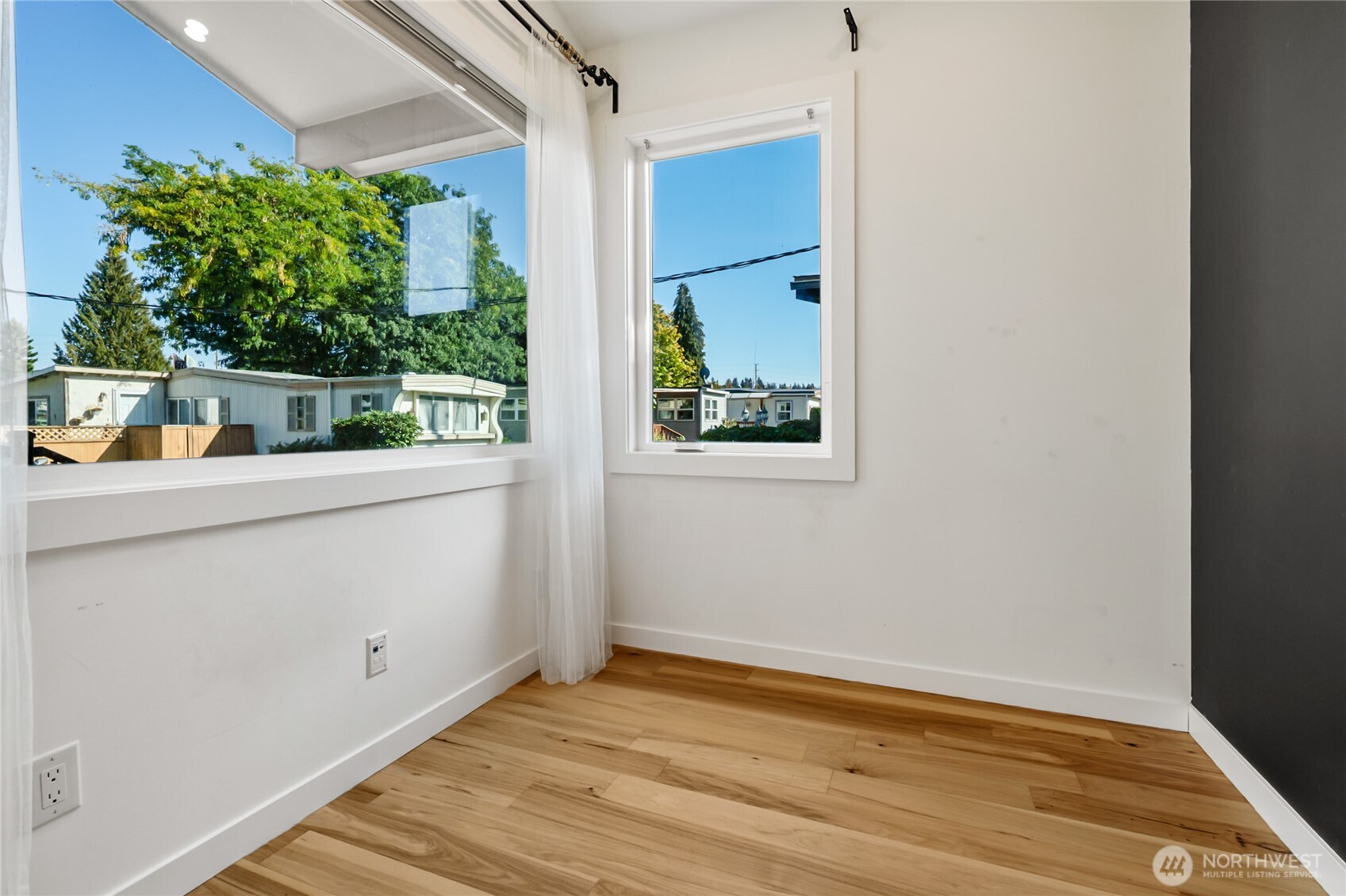 1645 South 272nd Street, Unit 55 Federal Way, WA 98003 - Photo 13 of 27 a view of empty room with wooden floor and fan