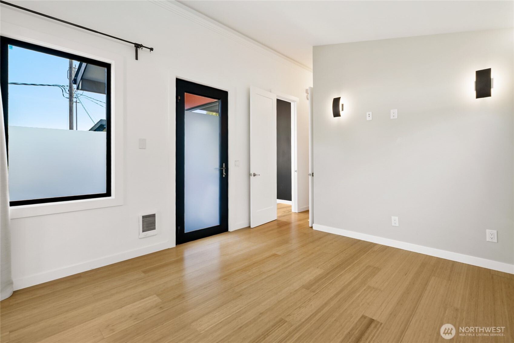 1645 South 272nd Street, Unit 55 Federal Way, WA 98003 - Photo 7 of 27 a view of an empty room with wooden floor and windows