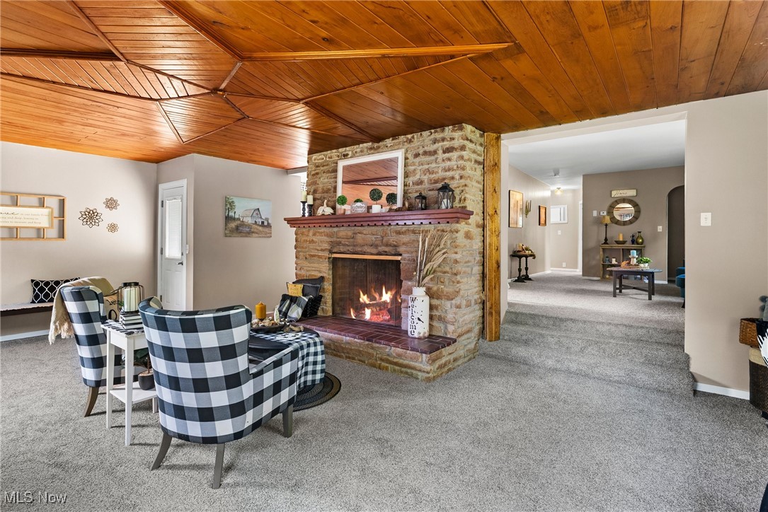 540 Park Road Painesville, OH 44077 - Photo 4 of 34 Living area with carpet flooring, wooden ceiling, and a fireplace
