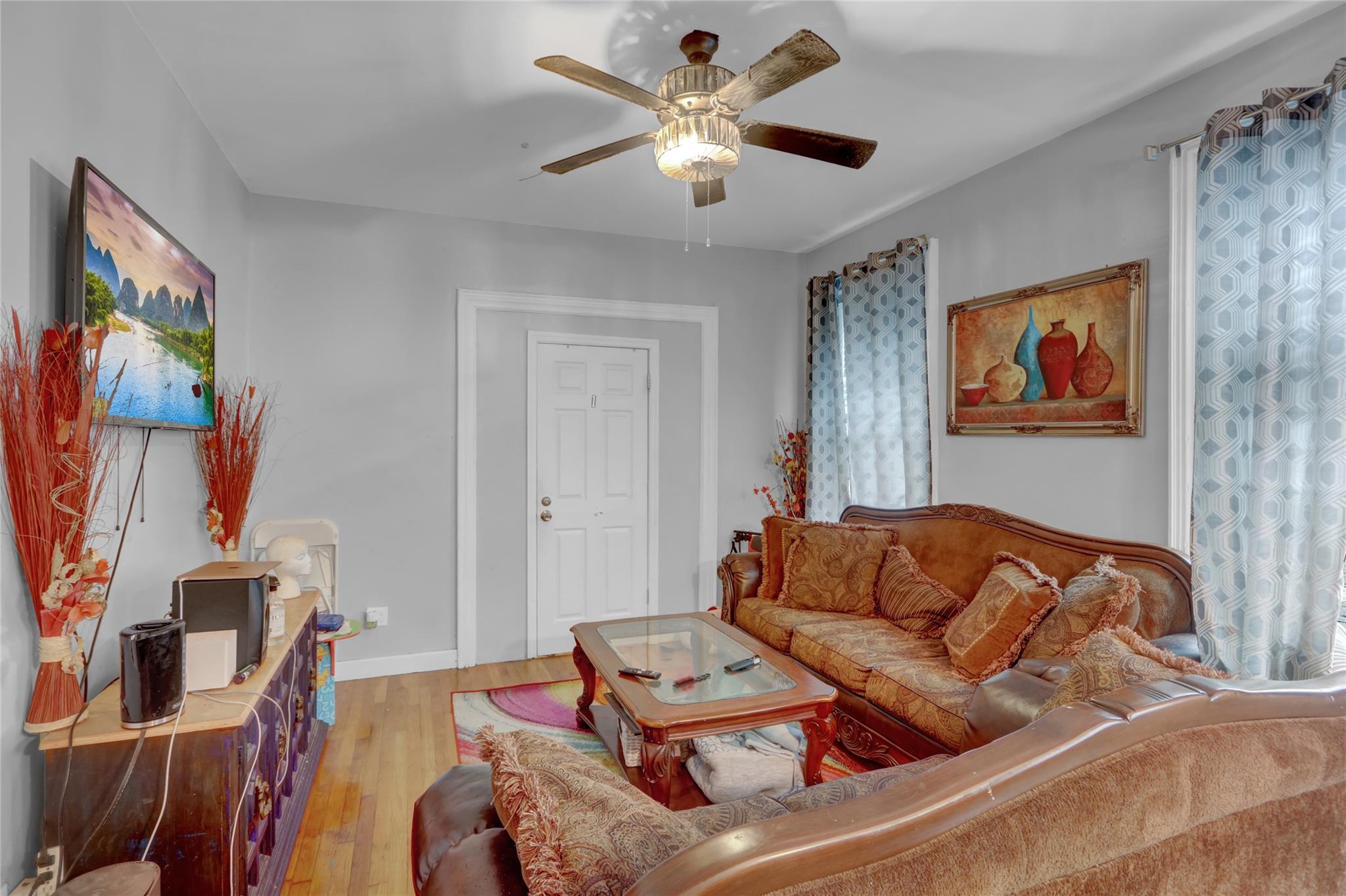 31 Tapscott Street Brooklyn, NY 11212 - Photo 4 of 10 Living area featuring light wood-type flooring and a ceiling fan