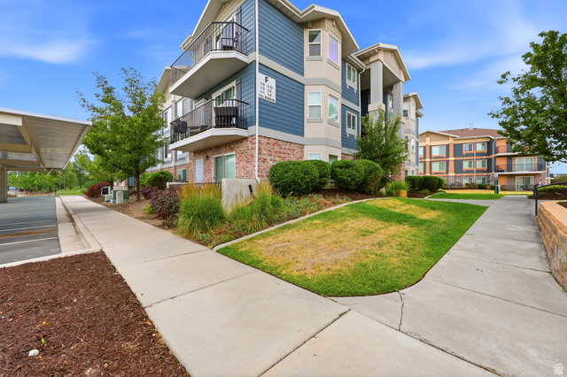 116 East Resaca Drive, Unit F6 Sandy, UT 84070 - Photo 3 of 32 Multi-story building featuring brick and siding exterior, private balconies, and covered parking