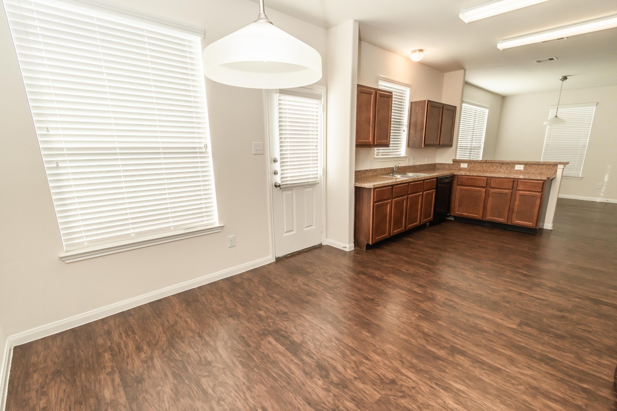 12 Santa Barbara Drive Manvel, TX 77578 - Photo 5 of 16 a kitchen with stainless steel appliances kitchen island wooden cabinets and a wooden floor