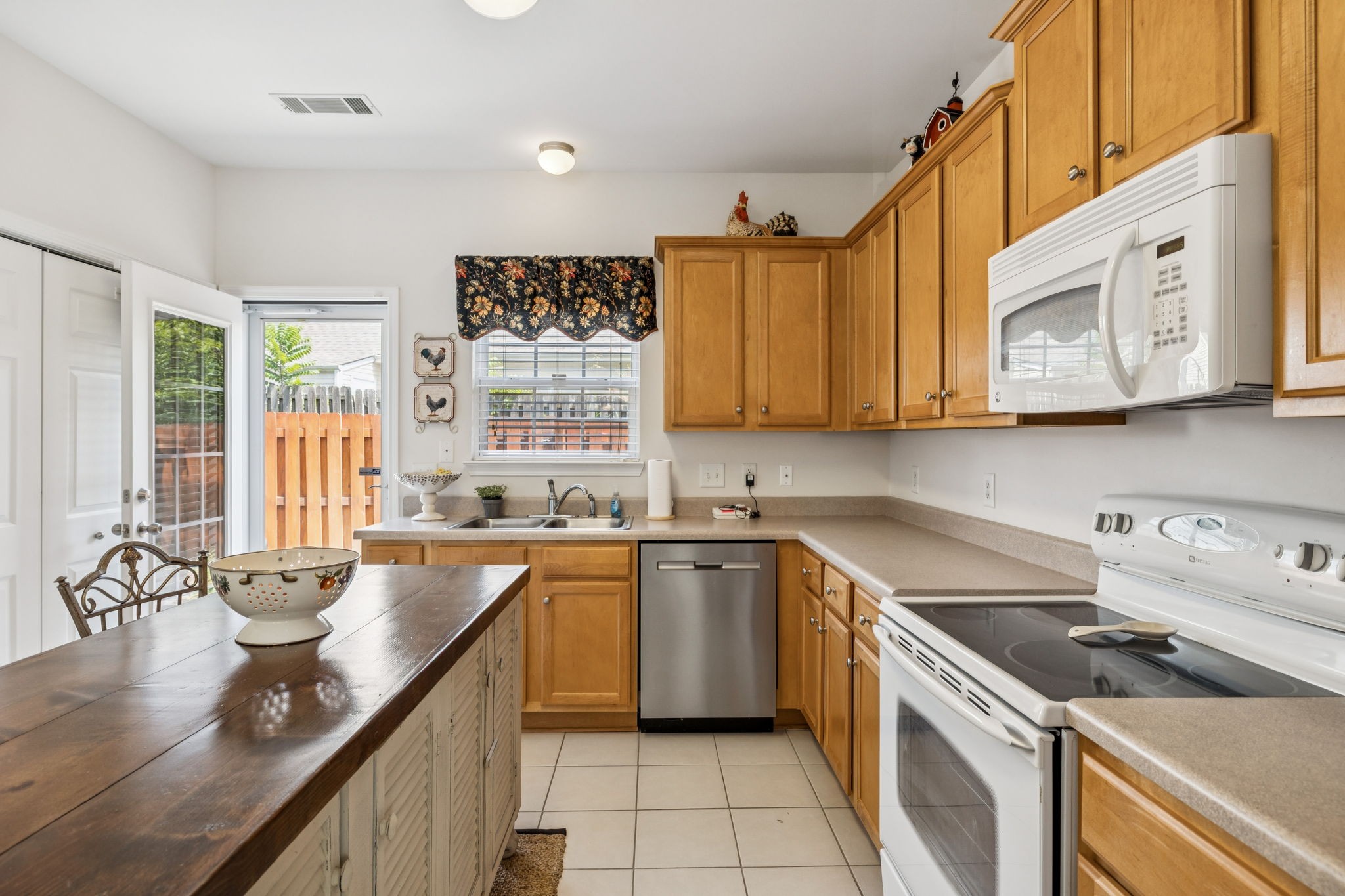 1101 Downs Boulevard, Unit 316 Franklin, TN 37064 - Photo 11 of 26 a kitchen with a sink stove top oven and cabinets