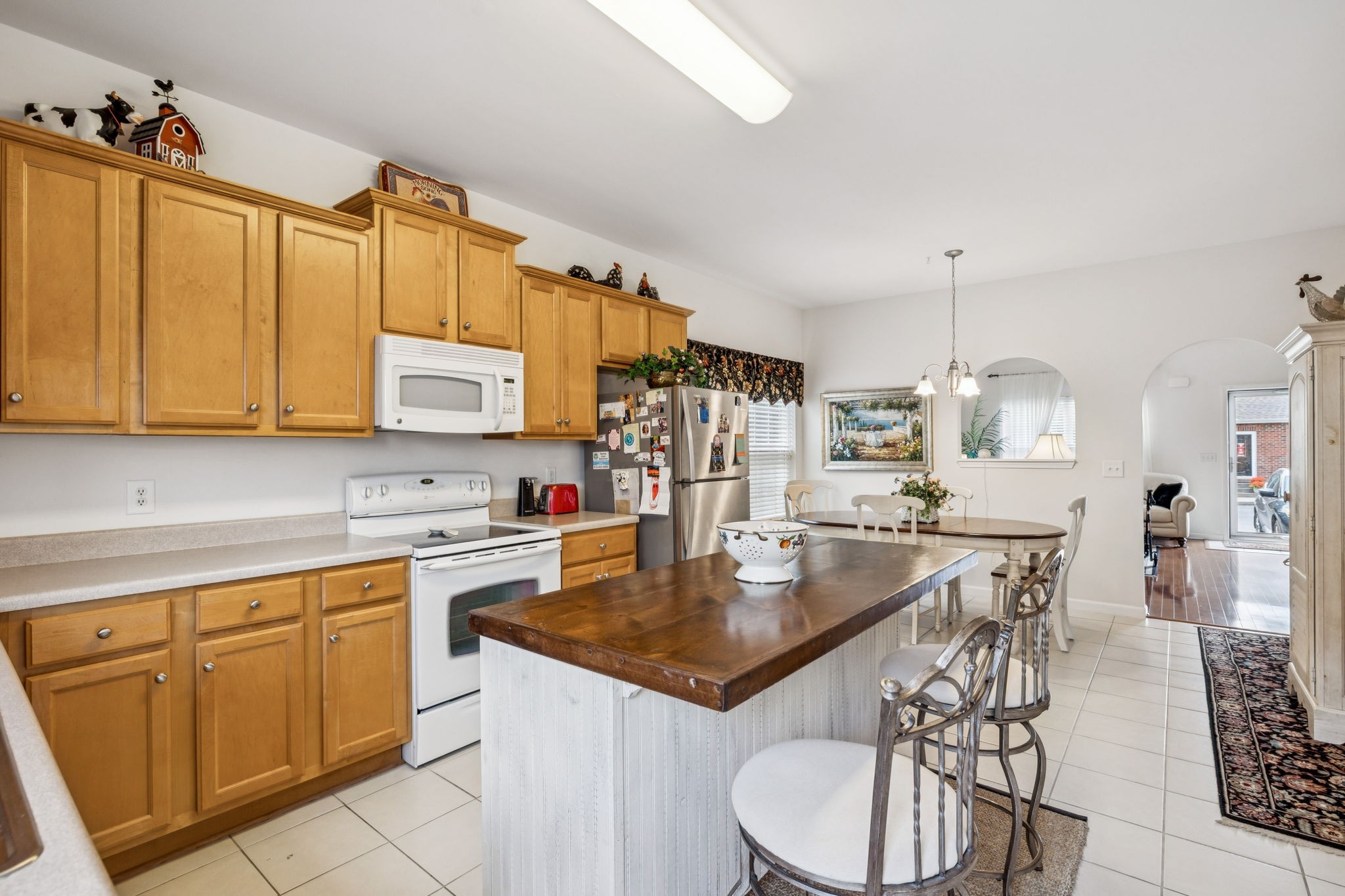 1101 Downs Boulevard, Unit 316 Franklin, TN 37064 - Photo 14 of 26 a kitchen with a table chairs stove and cabinets