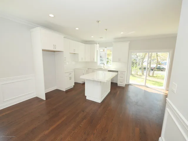 a large kitchen with a lot of counter space and a wooden floor
