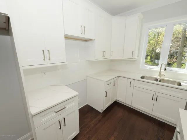 a kitchen with a sink cabinets and window