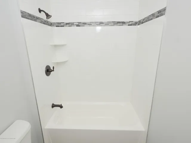 a bathroom with a shower and a bath tub