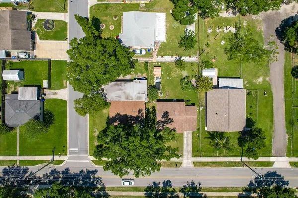 an aerial view of residential houses with outdoor space and street view