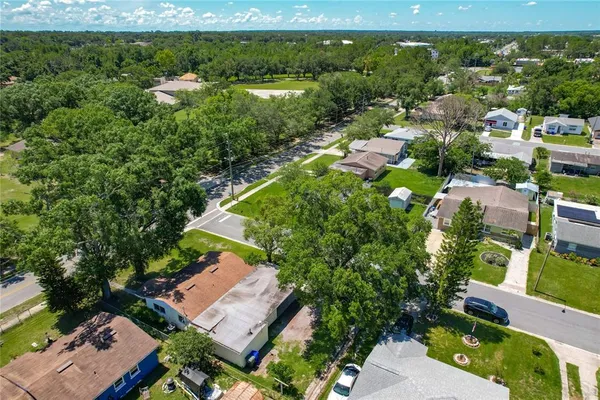 an aerial view of a house with a yard and fountain