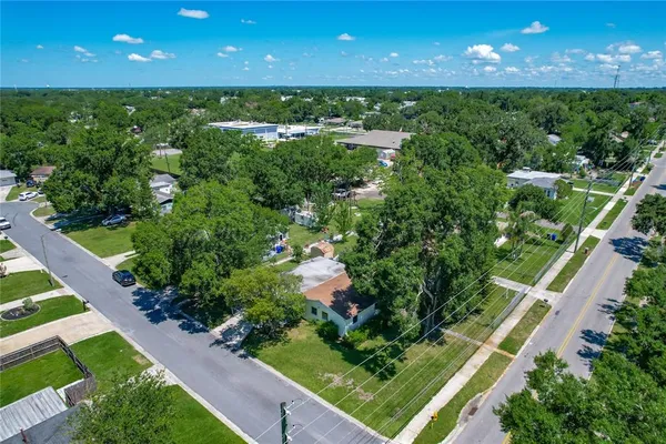 an aerial view of a house with a yard basket ball court and outdoor seating