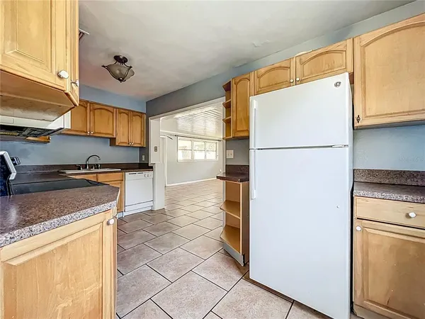 a kitchen with a refrigerator sink stove and cabinets