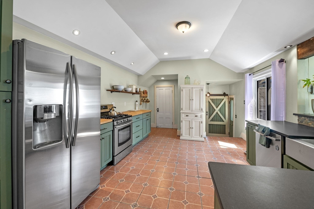 184 North Street Salem, MA 01970 - Photo 17 of 39 a large kitchen with stainless steel appliances kitchen island granite countertop a refrigerator and a sink