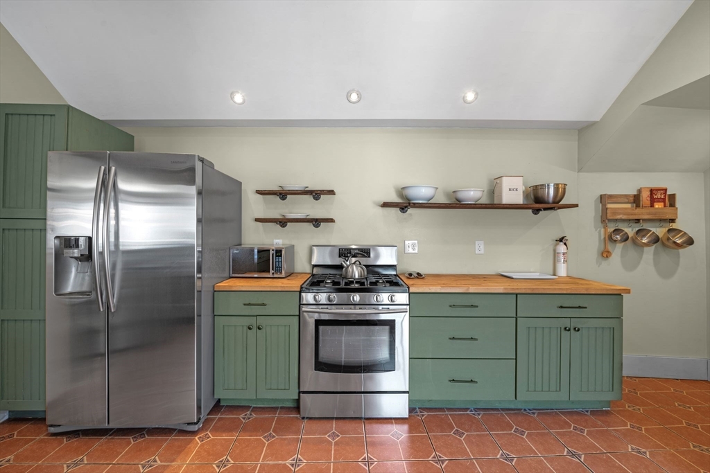 184 North Street Salem, MA 01970 - Photo 19 of 39 a kitchen with stainless steel appliances granite countertop a stove and a refrigerator