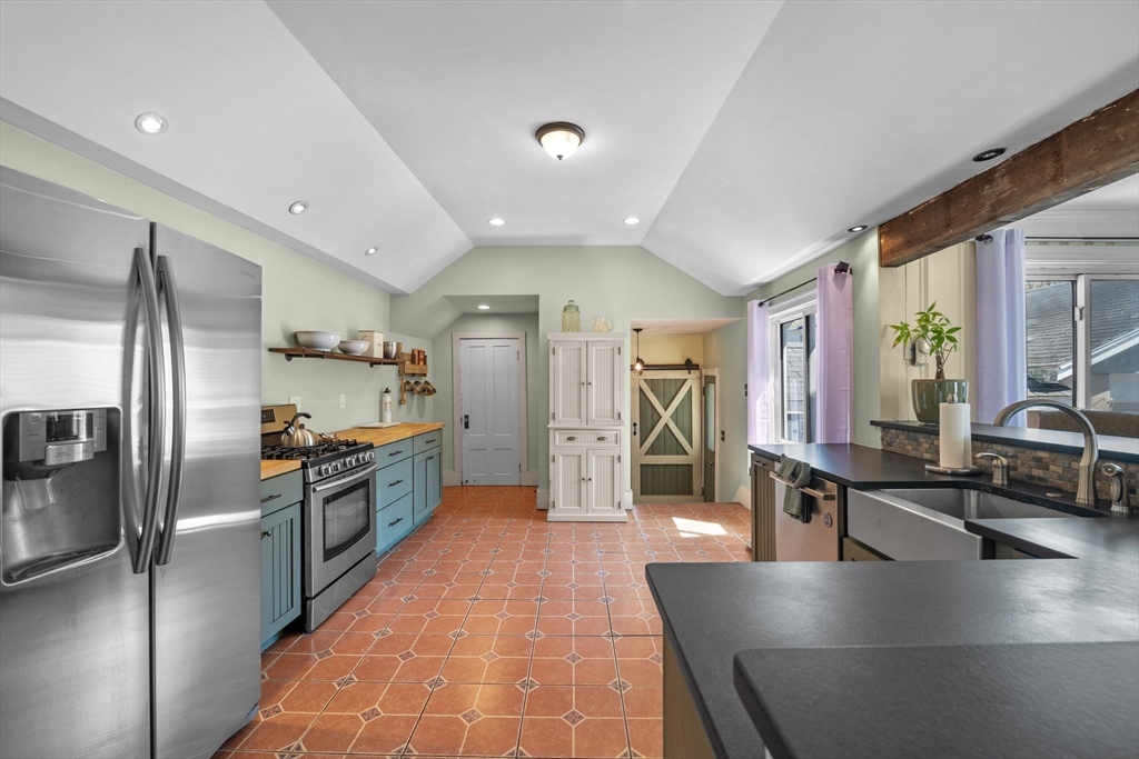 184 North Street Salem, MA 01970 - Photo 22 of 39 a kitchen with stainless steel appliances granite countertop a refrigerator and a sink