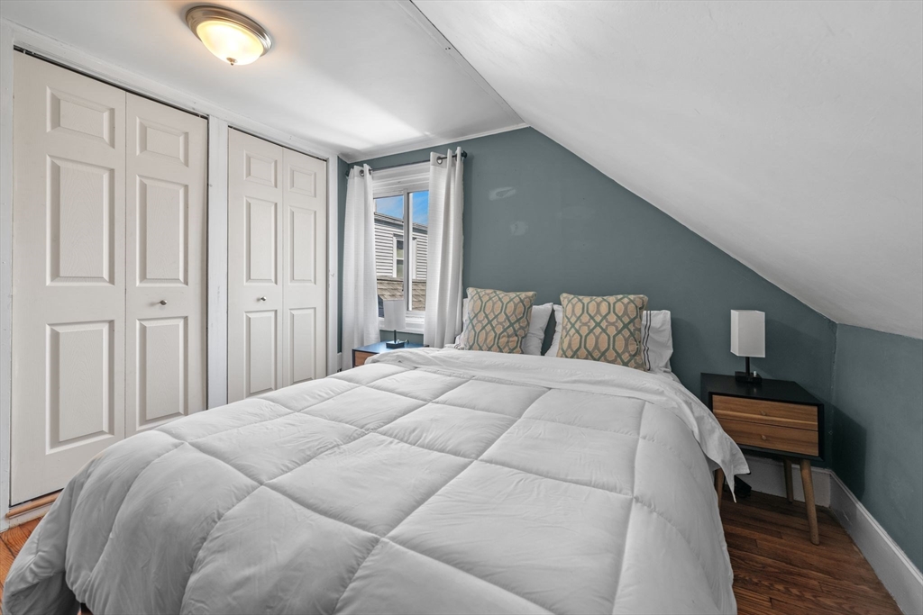 184 North Street Salem, MA 01970 - Photo 30 of 39 a bedroom with a bed and a lamp with wooden floor