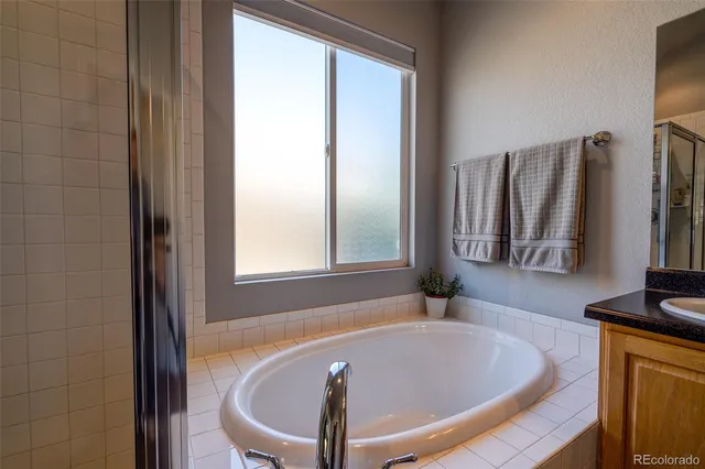 a bath tub sitting in a bathroom next to a window