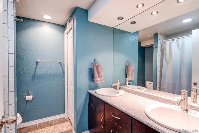 a bathroom with a sink vanity granite and a mirror