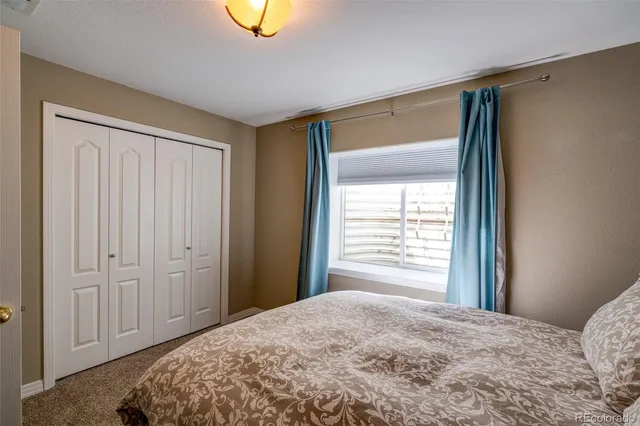 a bedroom with a bed and lamps