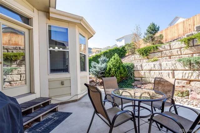 a outdoor space with a table and chairs