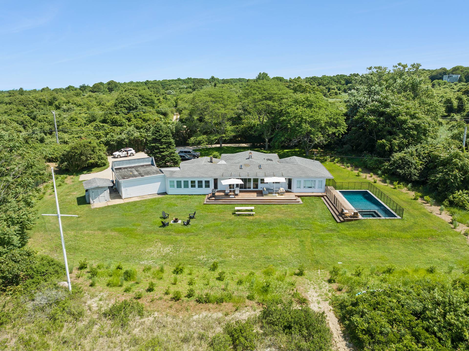 351 East Lake Drive Montauk, NY 11954 - Photo 28 of 30 a view of a house with swimming pool and mountains in the background