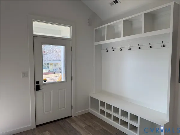 a view of wooden floor and windows