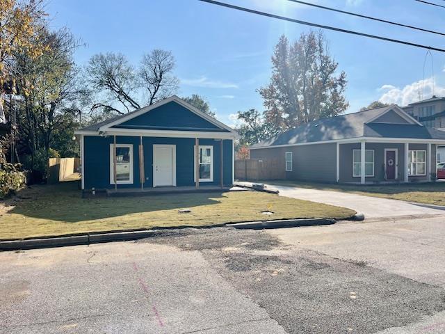 a view of a house with a swimming pool and a yard
