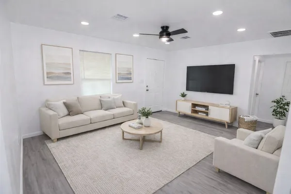 a living room with furniture and a flat screen tv