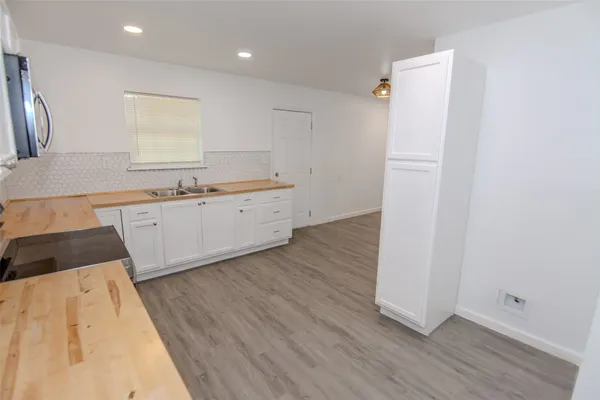 a kitchen with granite countertop a sink and steel appliances