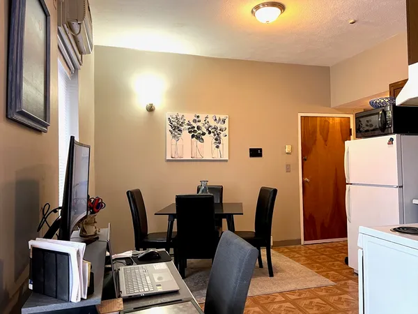 a view of a workspace with furniture and a flat screen tv