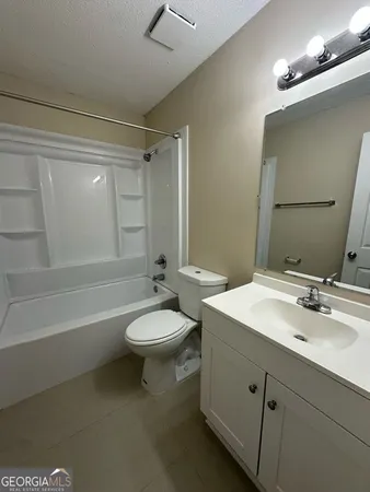 a bathroom with a double vanity sink toilet and shower