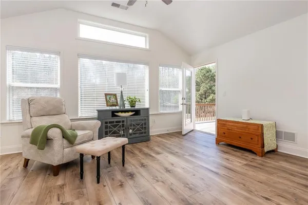 a living room with furniture and wooden floor