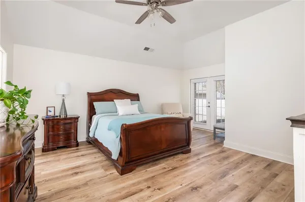 a bedroom with a bed and a potted plant
