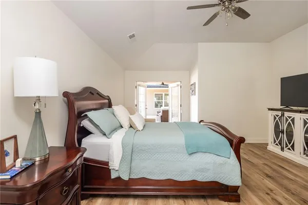 a bedroom with a bed and a flat screen tv