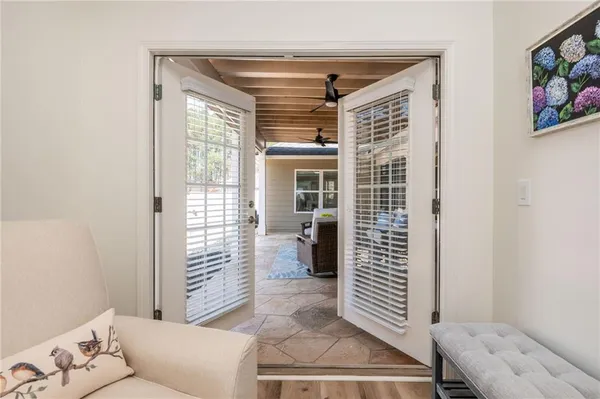 a living room with furniture and a potted plant