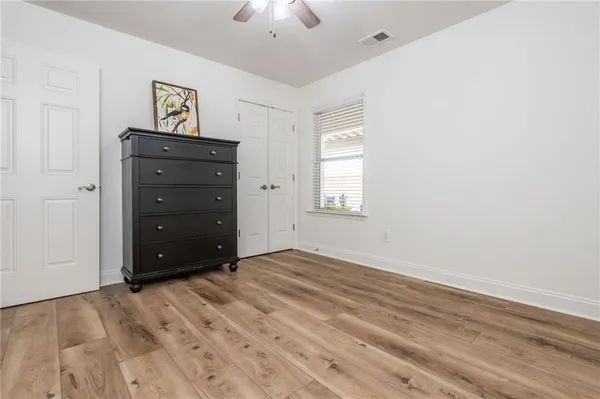 an empty room with windows and closet