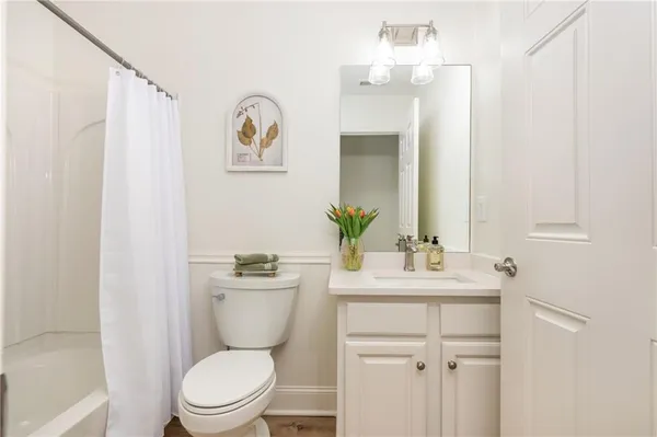 a bathroom with a toilet a sink and a mirror