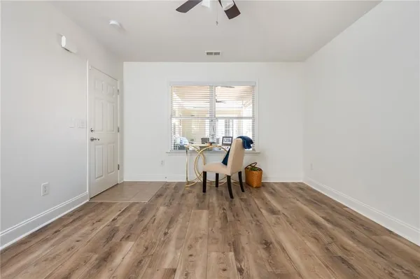 a view of a workspace with wooden floor