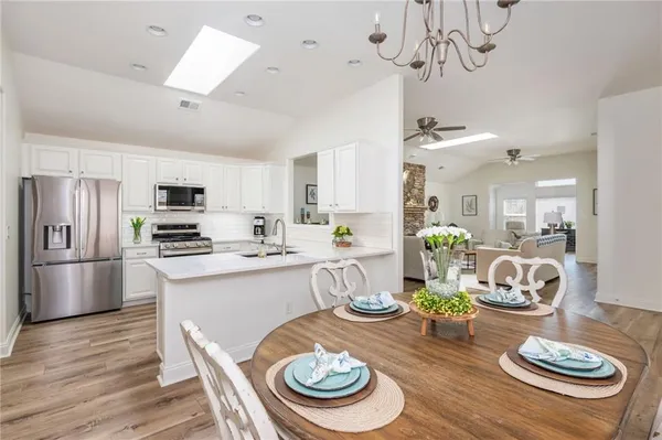 a kitchen with a dining table and chairs