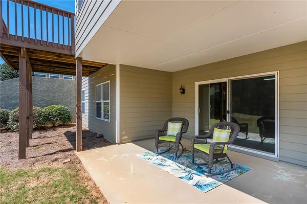 a building outdoor space with patio furniture and potted plants