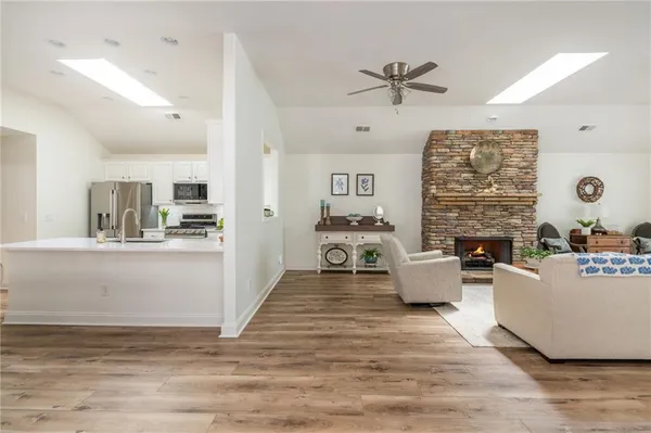 a living room with fireplace furniture and a wooden floor