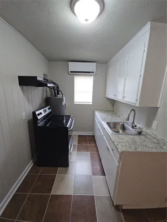 a kitchen with a sink a stove and refrigerator