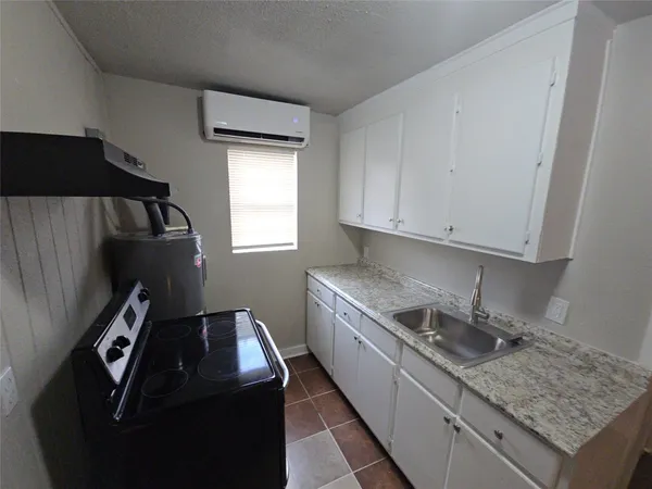 a kitchen with a sink stove and cabinets