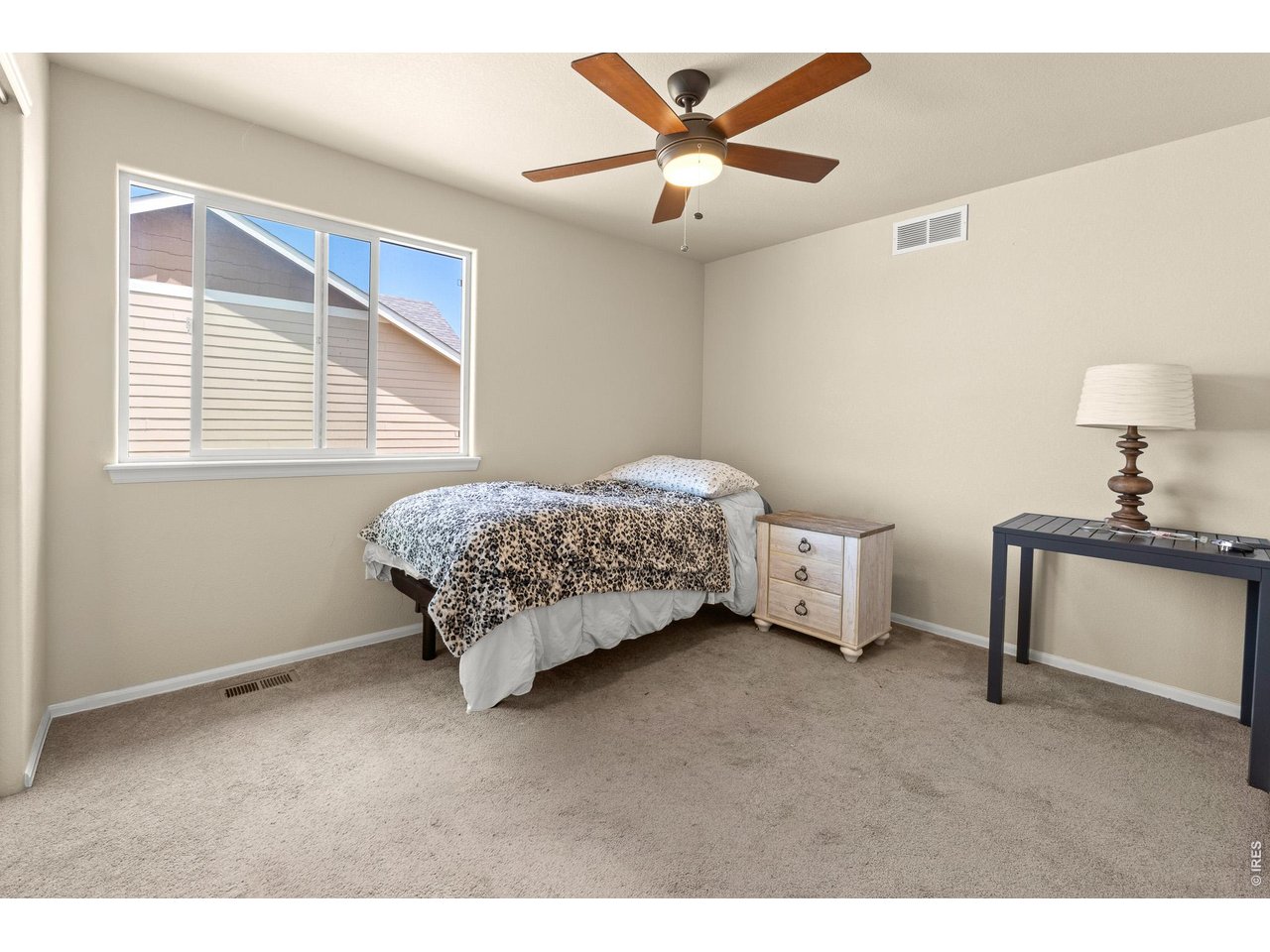 8847 16th St Road Greeley, CO 80634 - Photo 27 of 38 a bedroom with a bed and a chandelier